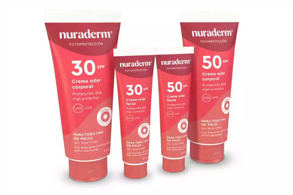 Cuatro tubos de crema solar Nuraderm con diferentes factores de protección solar para rostro y cuerpo sobre un fondo blanco