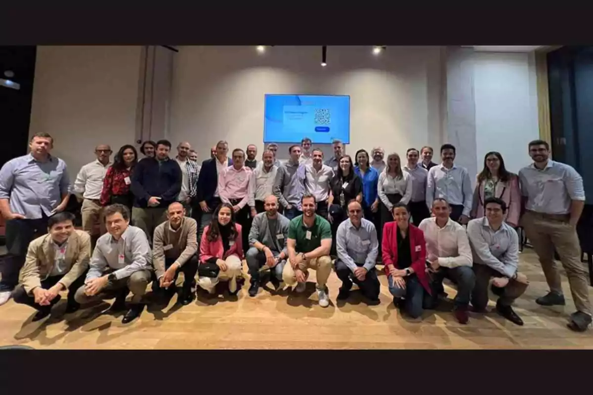 Un grupo de personas posando juntas en una sala de conferencias.