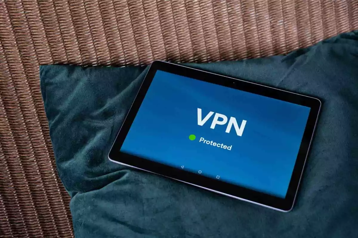 Una tableta sobre un cojín muestra una pantalla con el texto VPN Protected.